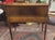Elenglant refined 1950s writing desk. Features clean large center drawer, wire mesh upper side cubbys, refined Napoleon...
