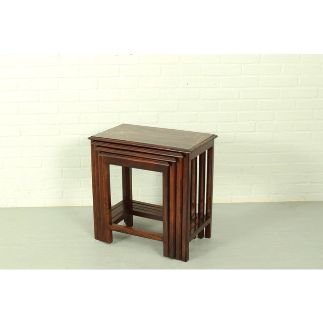 This set of four Italian mid‑century Indian rosewood nesting tables features clean lines, warm grain, and refined...