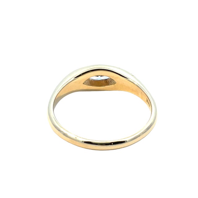 Elegant 18k yellow gold ring featuring a bezel-set marquise cut diamond weighing approximately 0.23 carats. Ring weighs 4...