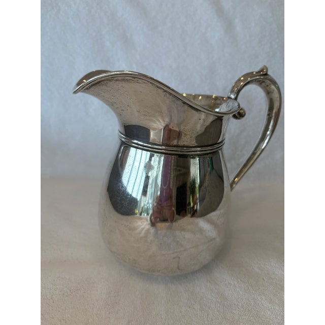 Simple lines create a beautiful design to this Sterling Silver Water Pitcher. A perfect addition to your home collection...