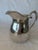 Simple lines create a beautiful design to this Sterling Silver Water Pitcher. A perfect addition to your home collection...