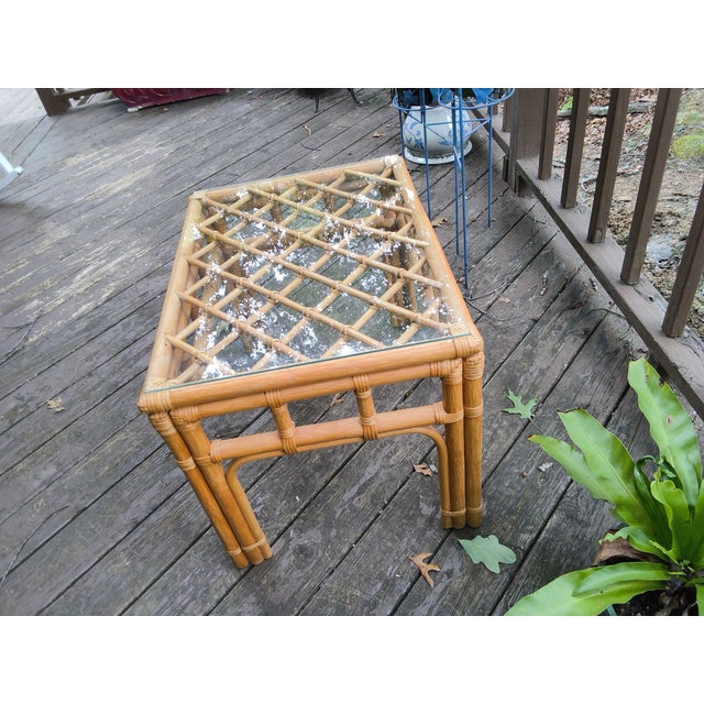 This 1950's era vintage-style rattan and glass end table features a distinctive lattice pattern top and sturdy bamboo...