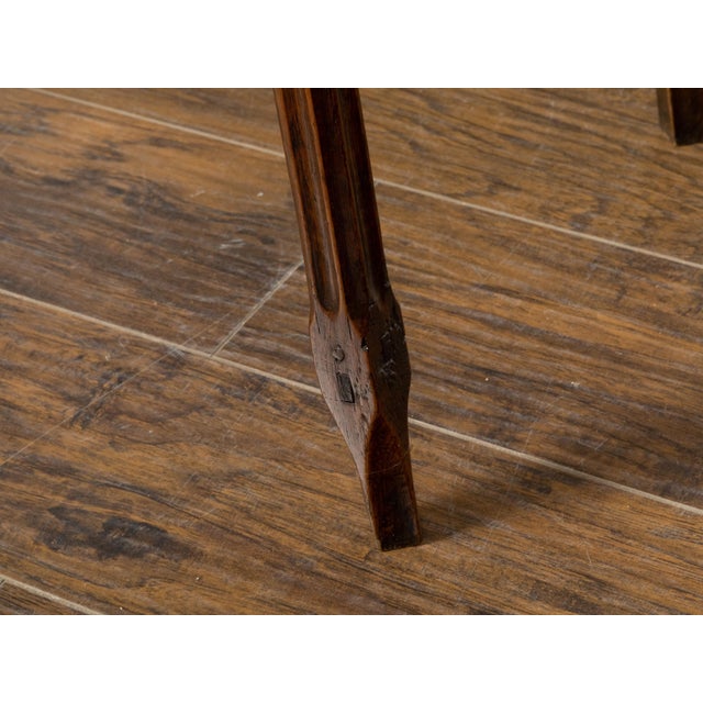 An English carved oak side table from the 19th century, with lift top, serpentine front, slender fluted legs, weathered...
