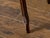 An English carved oak side table from the 19th century, with lift top, serpentine front, slender fluted legs, weathered...