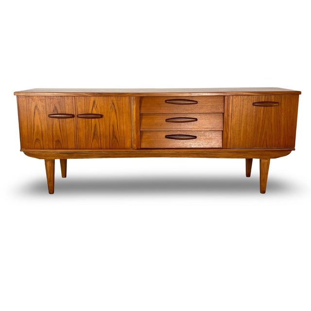 Vintage mid century long teak sideboard manufactured by the British company Beautility during the 1960s at their factory...