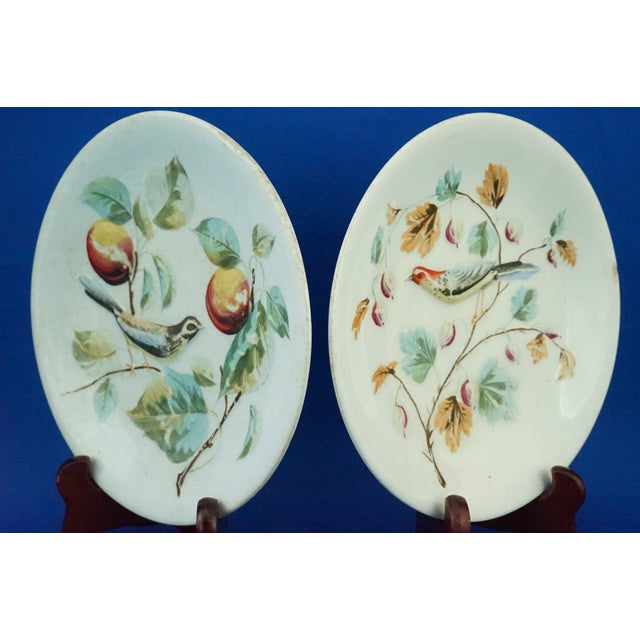 Item description: a delightful pair of glazed and vitrified ceramic plates, decorated entirely in bas-relief depicting...