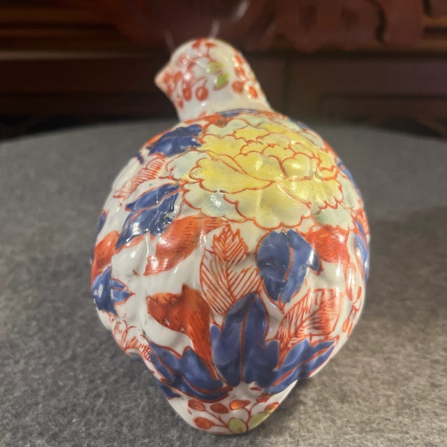 Decorated with hand painted red and blue flowers with white chrysanthemums. Chinese character marks on base.