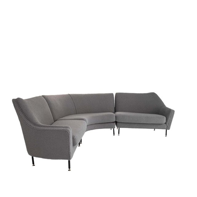 Corner sofa composed of three solid wood pieces with a metal elastic base. Artisanally upholstered in grey wool bouclé...
