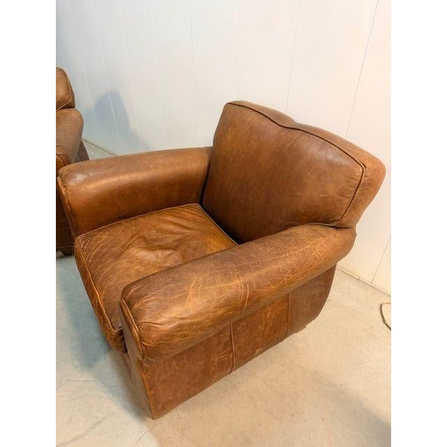 Classic and comfortable, this pair of Mitchell Gold tan leather club chairs is upholstered in rich, warm caramel leather...