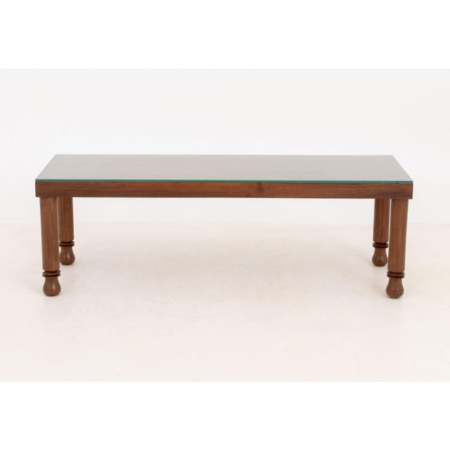 Modern Glass-Topped Walnut Coffee Table, the rectangular top above four cylindrical turned wood legs. 15.25" H x 45.75" W...