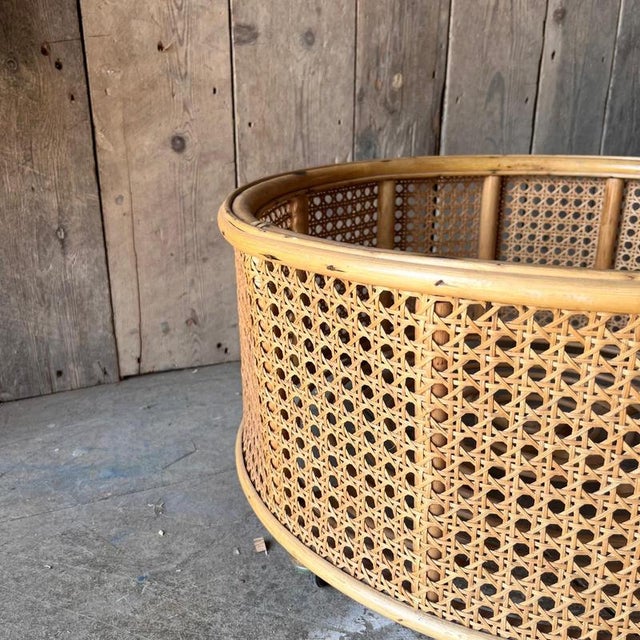Cane and Bamboo plant holder on wheels Dimensions 56cm diameter height 30cm inc wheels Height in planter 22cm excellent...