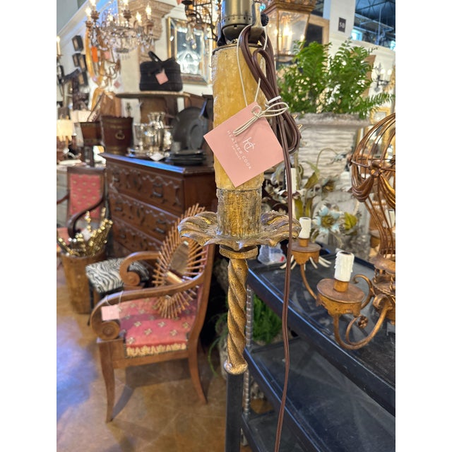 French gilt floor lamp with Leather detail and wax candle cover on a raised tripod base with curled feet. Newly rewired...