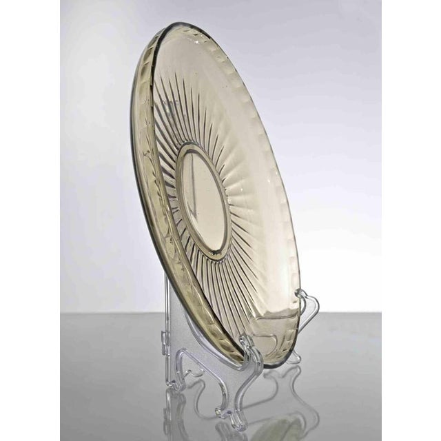 Vintage Art Glass Plate realized in Italy in 1970. Transparent beige with yellow nuances Very good condition.