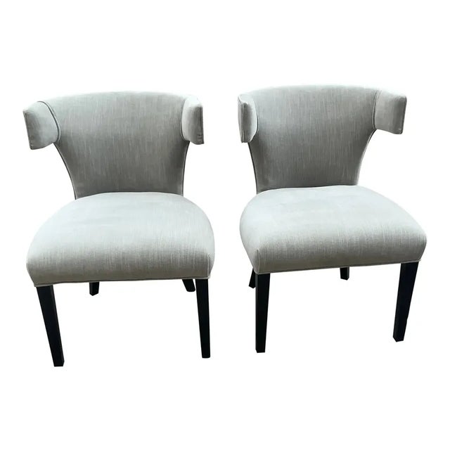Vintage set of Klismos dining chairs. The set is upholstered in a grey chenille. The legs are ebony black. Well made. We...