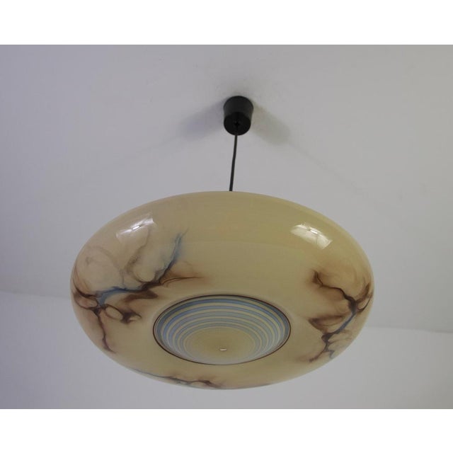 This striking art deco glass pendant lamp from 1930s germany is a refined example of early modern lighting design. Its...