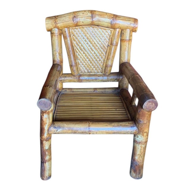 From the 1980s, this is a pair armchairs featuring very large, mature stalks of cut bamboo constructed to create oversized...