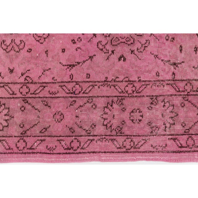 This is a vintage Turkish Oushak rug from the Mid 20th Century. The piece was hand-knotted.