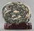 Chinese Natural Form Oval Dreamstone, with mountainous landscape, mounted on carved wood stand. 10.5" H x 10.5" W x 3" D....