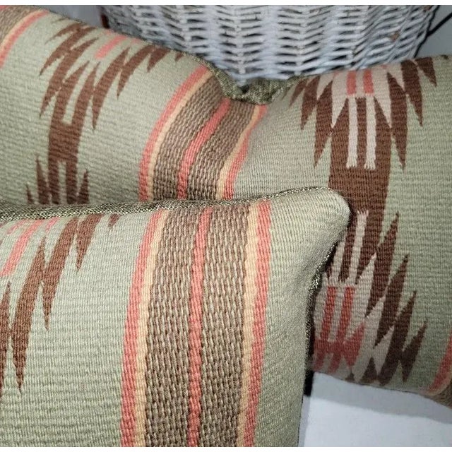 Salmon & khaki green woven bolster pillows.The backings are in a thick sage green linen.Down & feather fill. Sold as a pair.