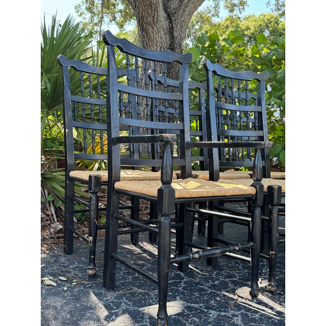 A charming set of six vintage dining chairs featuring a timeless blend of spindle-back and ladder-back designs. Finished...