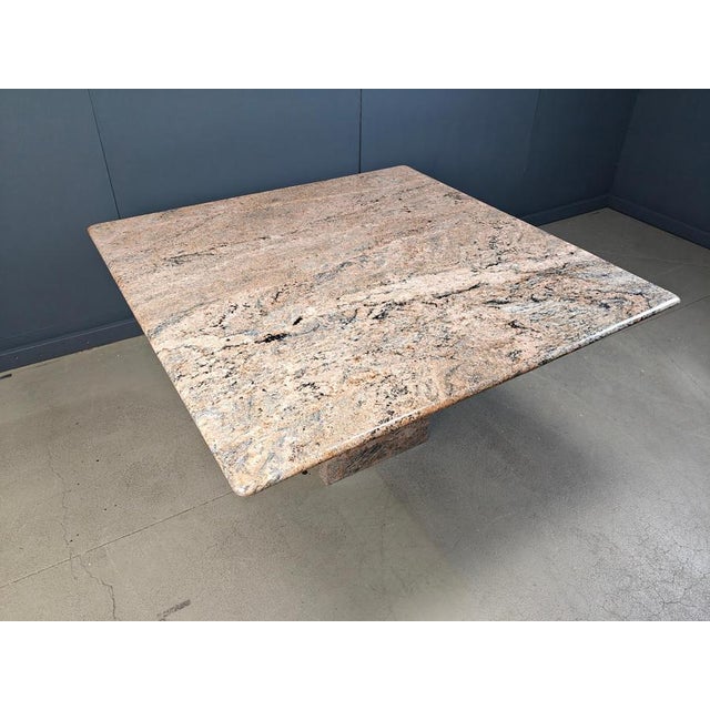 Large granite square dining table with beautiful natural stone pattern and a central lag. The edges have been honed so no...