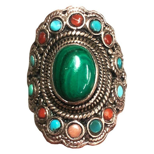 This silver gem pendant ring is adorned with a mesmerizing Malachite gem at its heart. Surrounding the central beauty are...