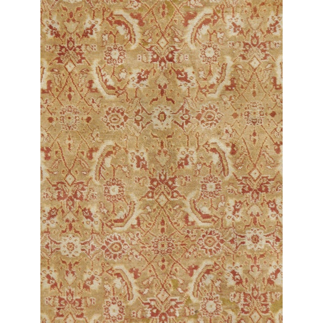 An antique Indian Agra rug from the early 20th century utilizing a large-scale rendition of the popular Persian "Herati"...