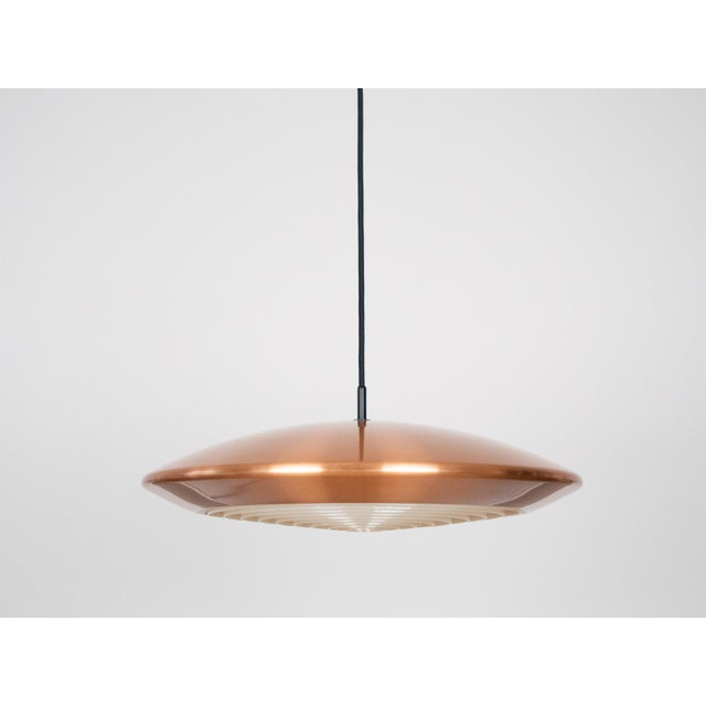 The Diskos lamp, designed by Jo Hammerborg, is a classic example of Danish modernist design, distinguished by its elegant...