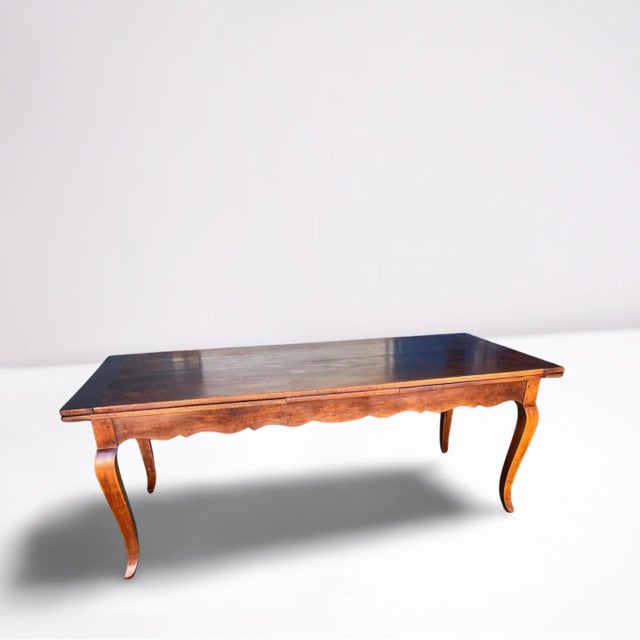 This late 1800's French antique dining table exudes timeless sophistication. Crafted from cherry wood, its rich, warm hue...