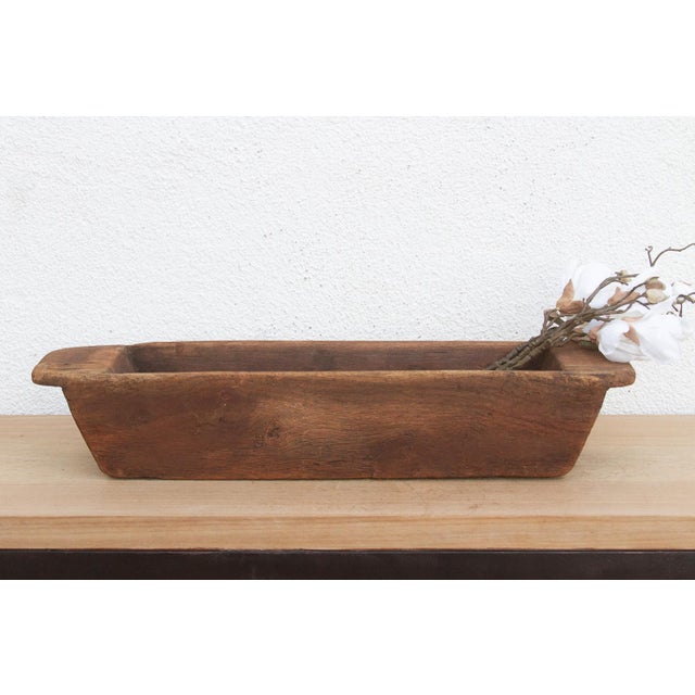 Carved from a single, massive log of hardwood, this antique wooden trough was likely originally used in a village setting...