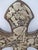 Traditional Mexican folk art wall cross made from carved wood and heavily embellished with metal Milagro charms. Larger...