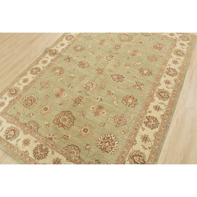 This modern traditional Ziegler rug is hand-knotted with an all-wool pile on a cotton foundation. This rug is new and in...