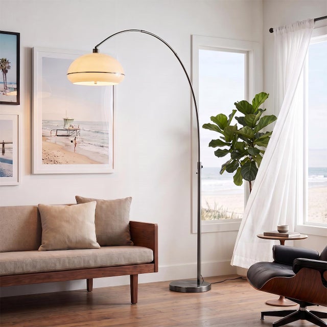 Designed by Peter Morelli in 1960, the Morelli Arc Lamp is a modern masterpiece featuring a sleek black nickel finish and...