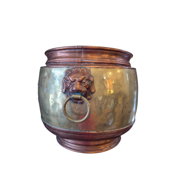This fabulous French brass and copper jardiniere circa early 1900s offers plenty of presence and panache. Featuring lion...