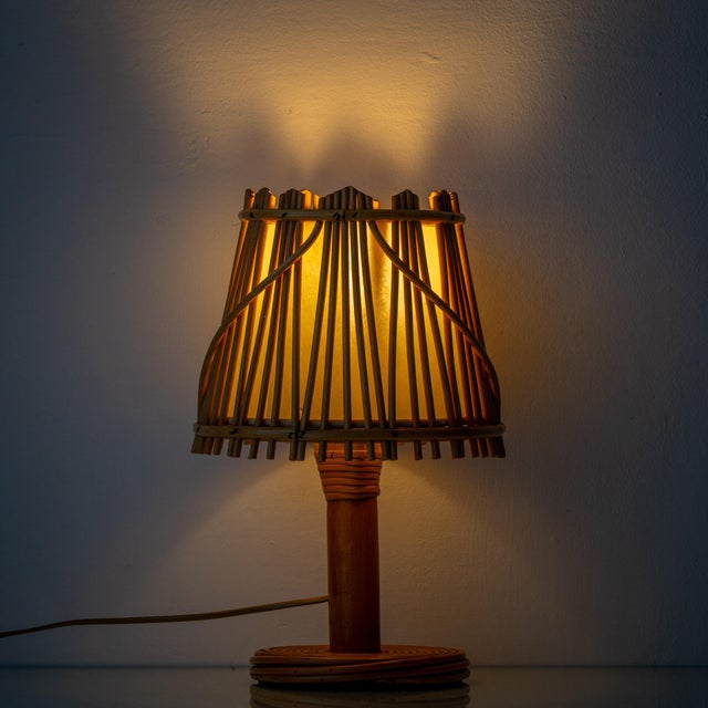 A pair of riviera rattan table lamps from the 1960s, made in the manner of louis sognot. Both are newly rewired for the us...