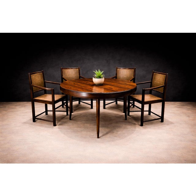These armchairs are crafted from solid Brazilian rosewood and feature handwoven cane seats and backs, reflecting a...