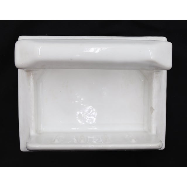 Flush mount rectangular bathroom soap dish made of white porcelain over ceramic with a handle. Made by Fairfacts Co. Good...
