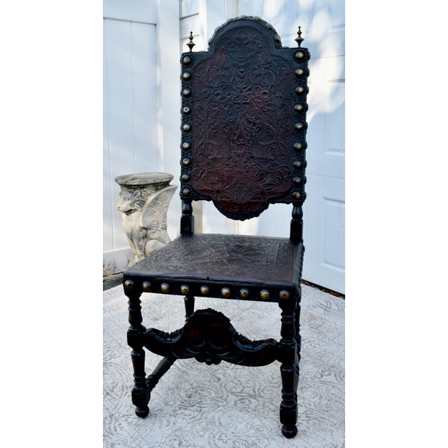Antique Early 19th Century High Back Chair has a Tudor Style. Made of Wood. Walnut and Tooled Leather, Brass Studs, and...