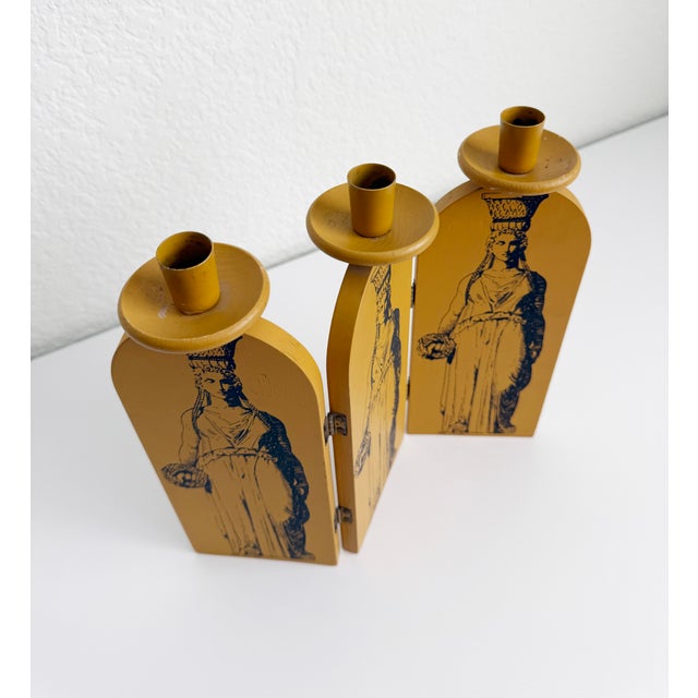 A rare and unique vintage folding candle holder that takes inspiration from iconic Italian designer Fornasetti. The piece...