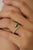 This bypass ring features a 0.49 carat pear-shaped emerald set in 14K yellow gold. The emerald measuring 5 x 8 mm, secured...