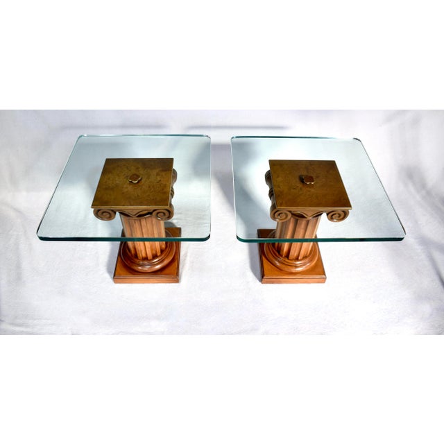 A pair of Ionic column Burl Walnut pedestal tables in the Neoclassical style with 1/2" glass tops by John Stuart; circa...