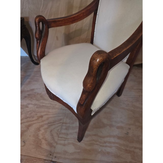 Beautiful antique armchair with carved wood swan head arms and slightly carved wood back.