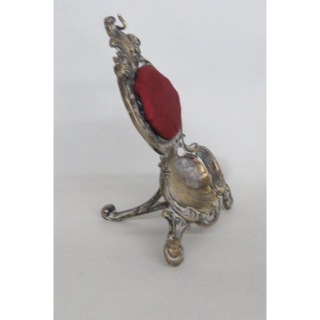 This beautiful Pocket Watch Holder is made of metal and fabric. It presents a lovely warm brass-tone to the metal, a top...