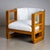 An elegant Art Deco armchair featuring a softly rounded frame and distinctive rectangular cut-outs at armrest height....