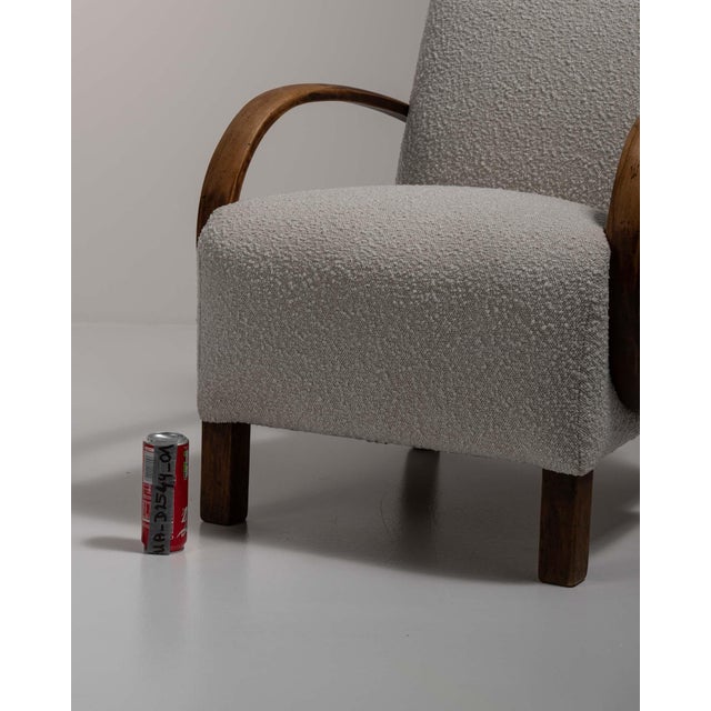 A blue wood armchair by Jindřich Halabala, dating to the 20th century and made in Czechia. The wood frame is finished in...