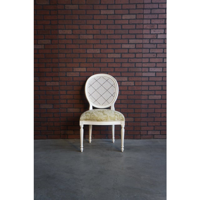 Charming French-inspired cane back chairs by Ethan Allen. These Chrystiane chairs feature the hand painted lattice pattern...