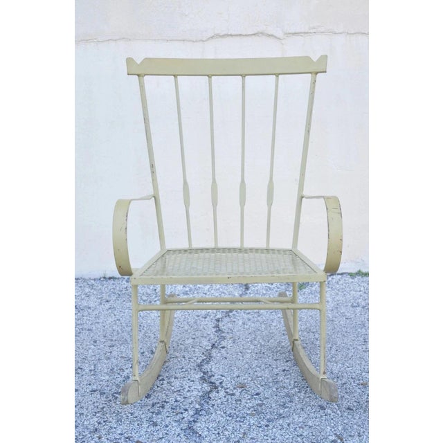 Vintage Mid Century Modern Wrought Iron Rocking Chair after Salterini and Arthur Umanoff. Item features wooden runners,...