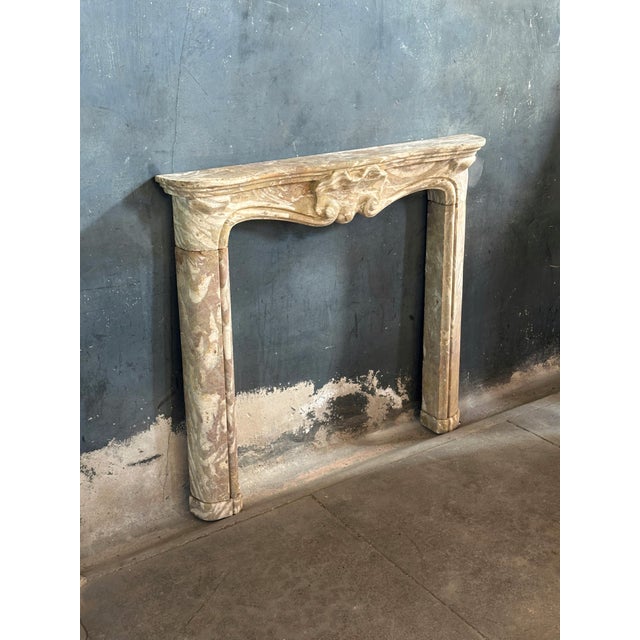 Stunning example of a 18th century French Louis XV mantle featuring a beautiful central clam shell carving. Simple and...