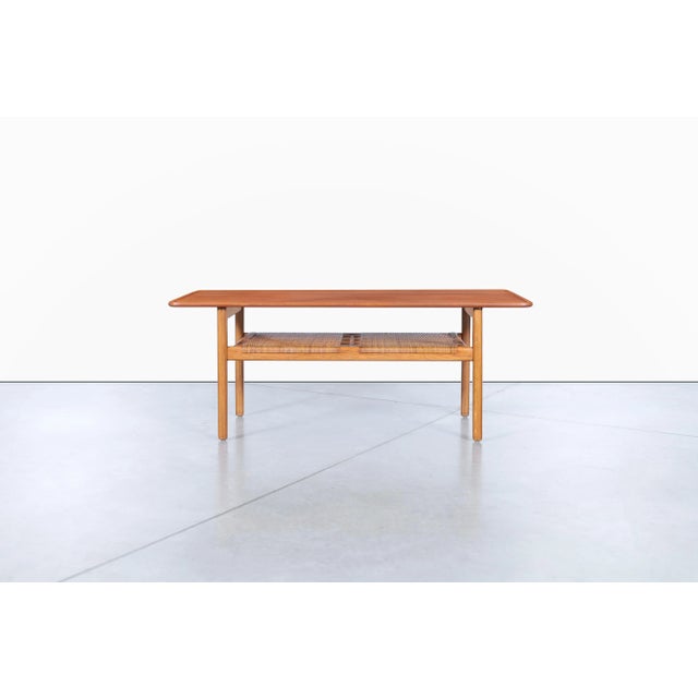 The Scandinavian AT-10 coffee table, designed by Hans J. Wegner for Andreas Tuck in the 1950s, embodies the philosophy...