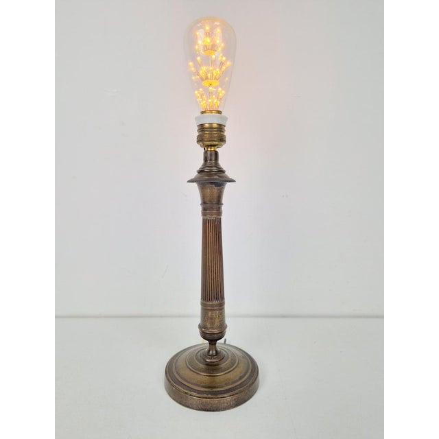 Vintage bronze table lamp with an Empire-style base, late 19th century Circa 1890, France A late 19th-century bronze...